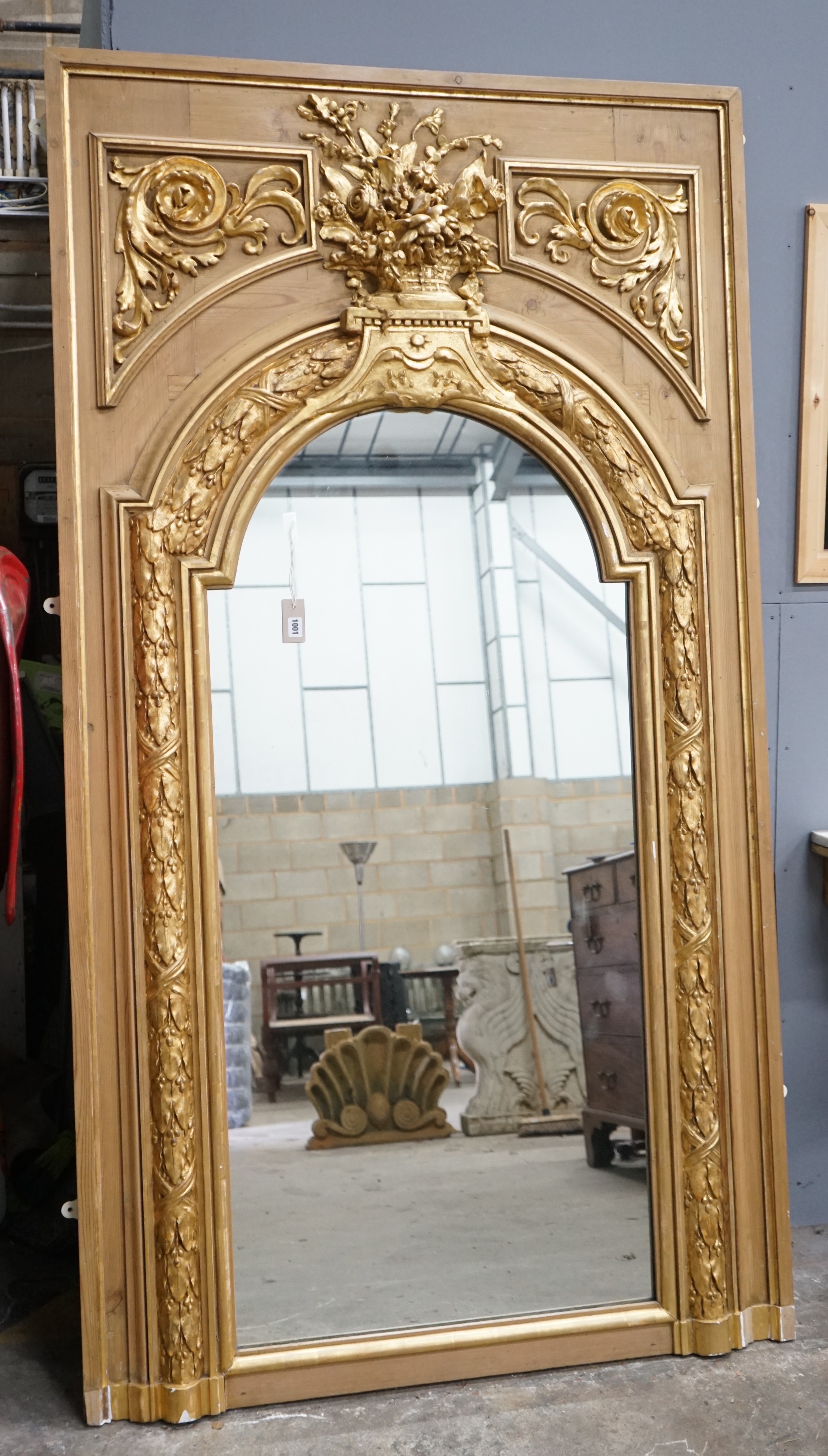A Victorian pitch pine and gilt composition wall mirror the arched plate with floral vase surmount, width 117cm, height 212cm